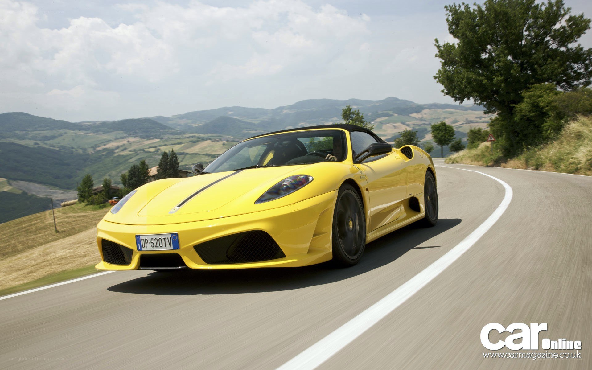Yellow Ferrari on winding road