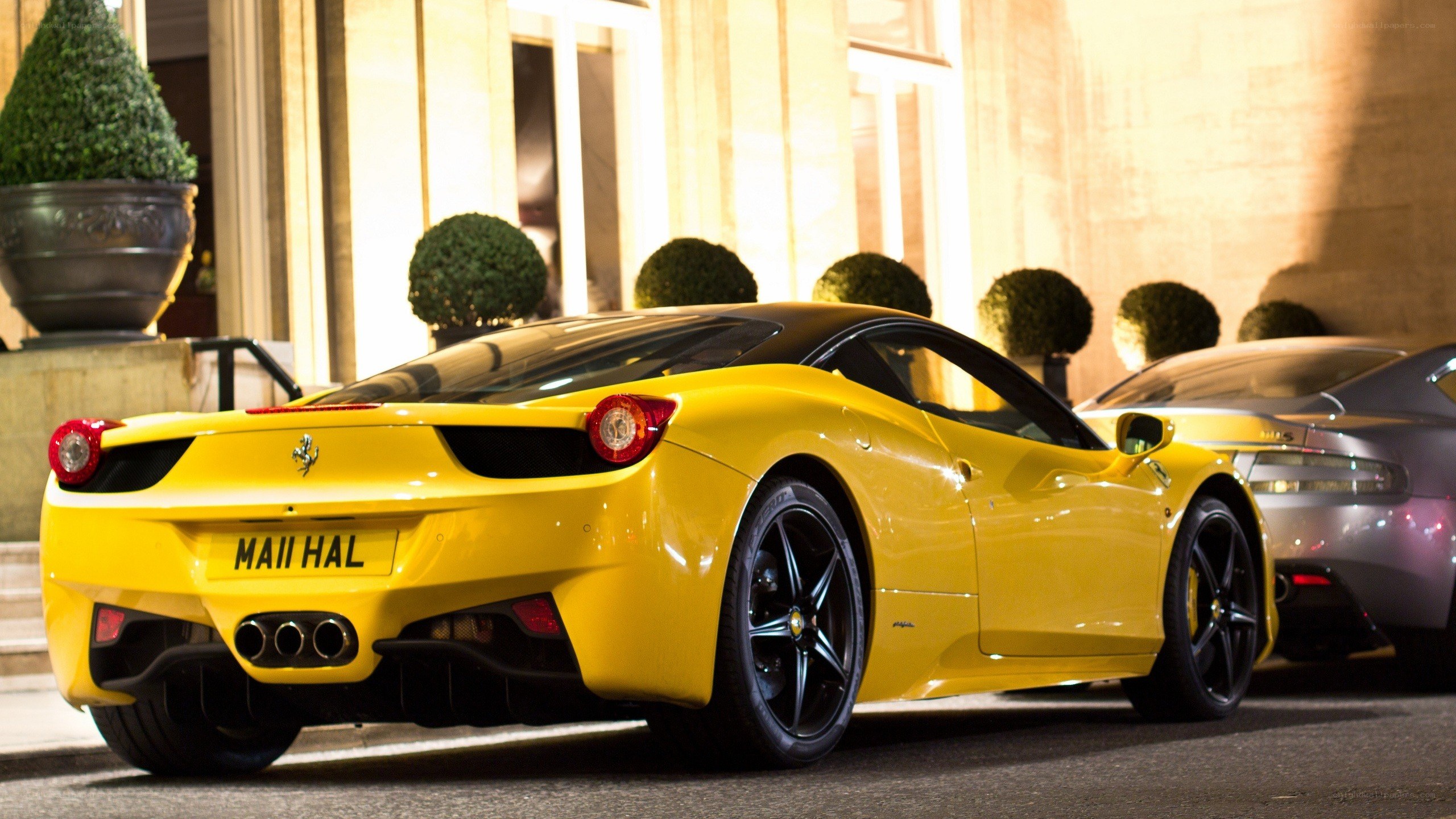 Yellow Ferrari parked at night