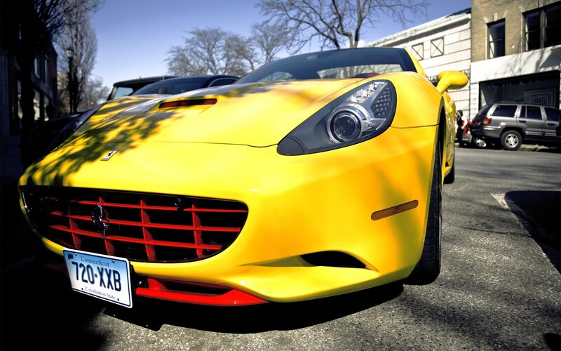 Yellow Ferrari parked on street