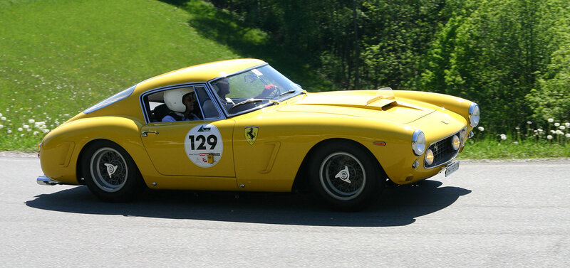 Yellow Ferrari race car on road