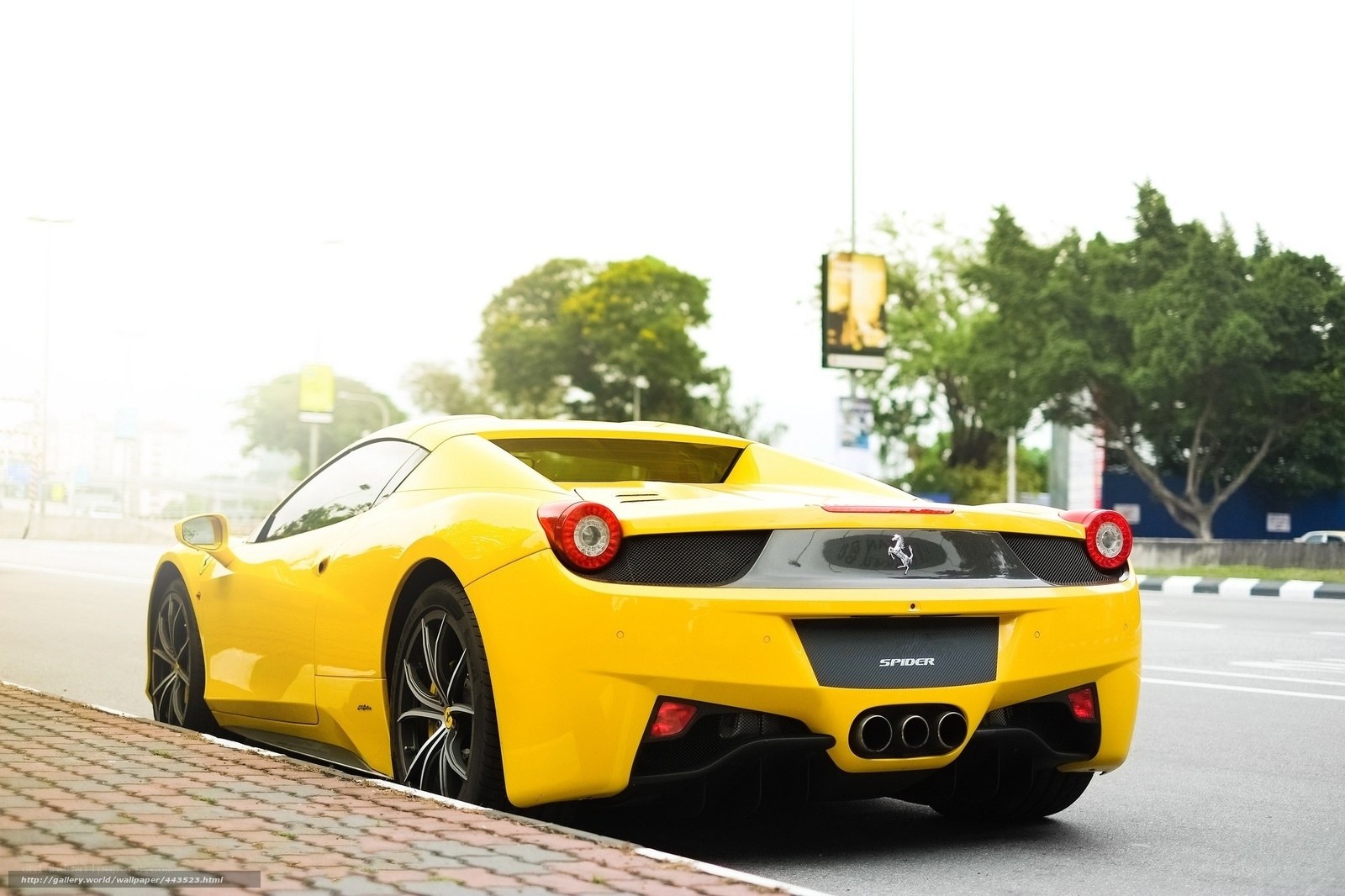yellow ferrari spider parked
