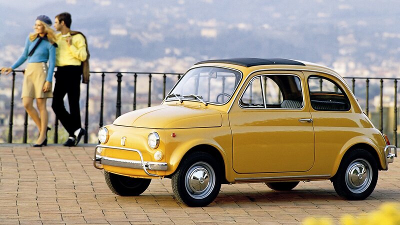 Yellow Fiat 500 on a scenic overlook