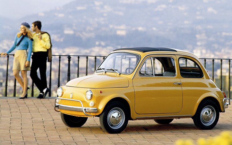 Yellow Fiat 500 on a scenic overlook