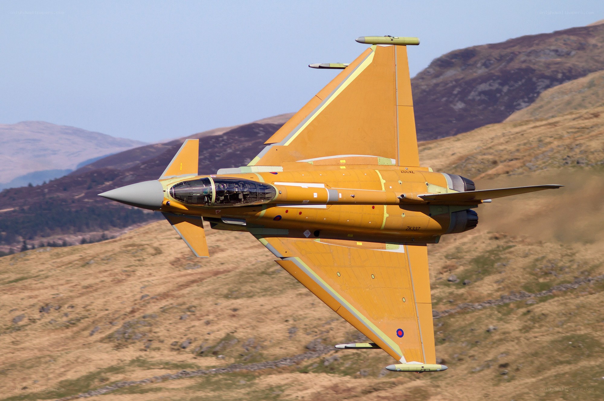 Yellow fighter jet in flight