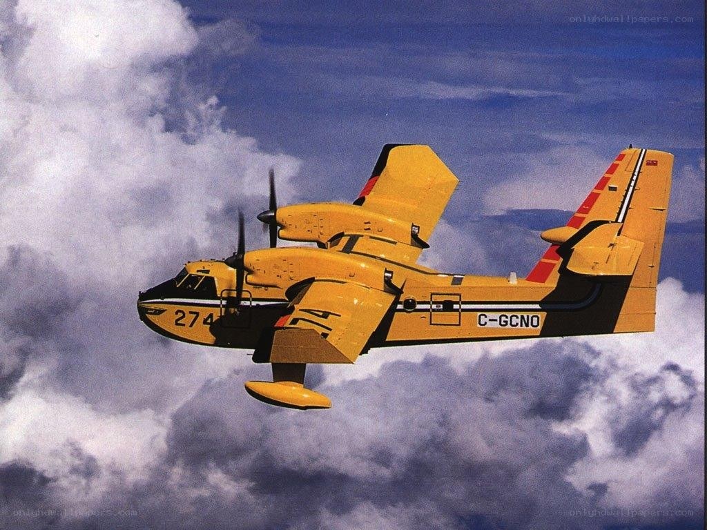 Yellow firefighting aircraft in flight