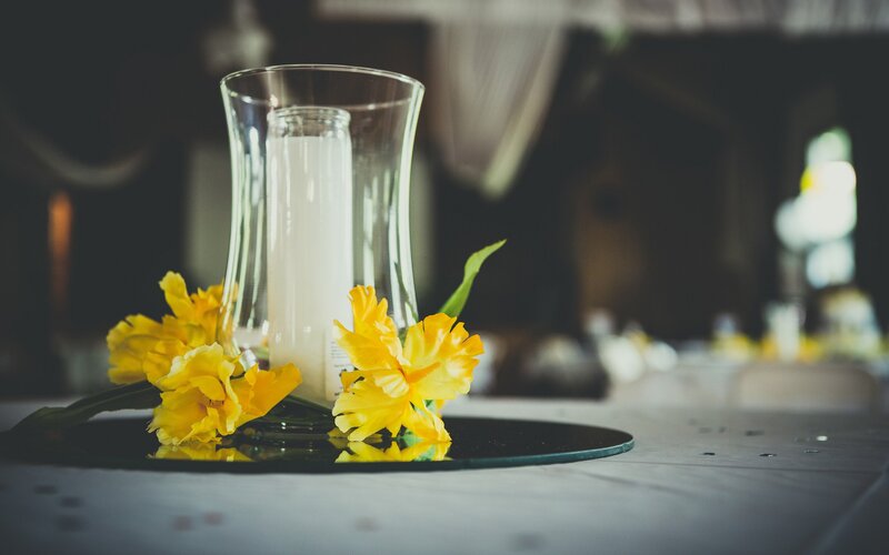 Yellow flowers and candle centerpiece