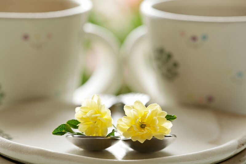 Yellow flowers on spoons