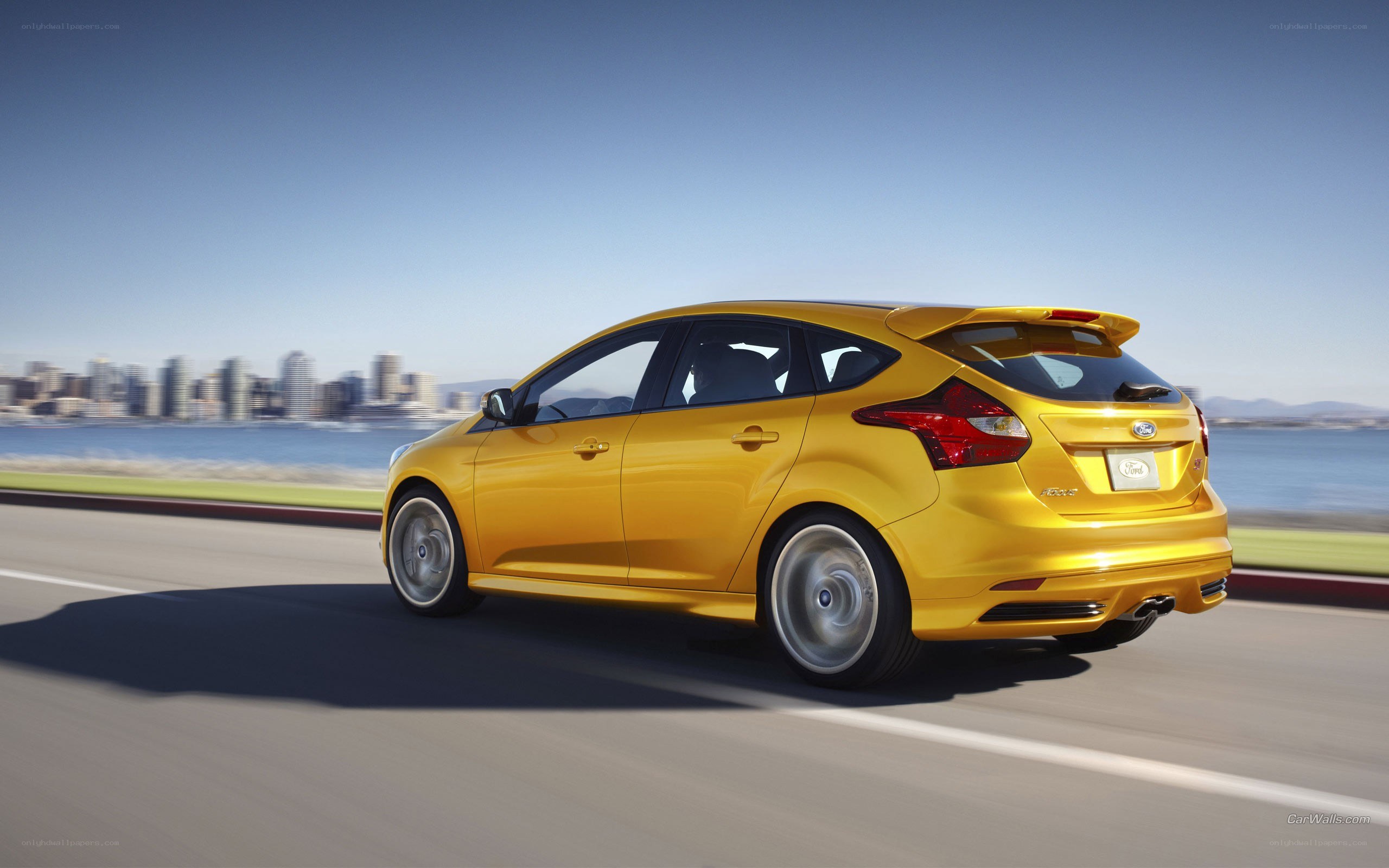 yellow ford focus driving on road