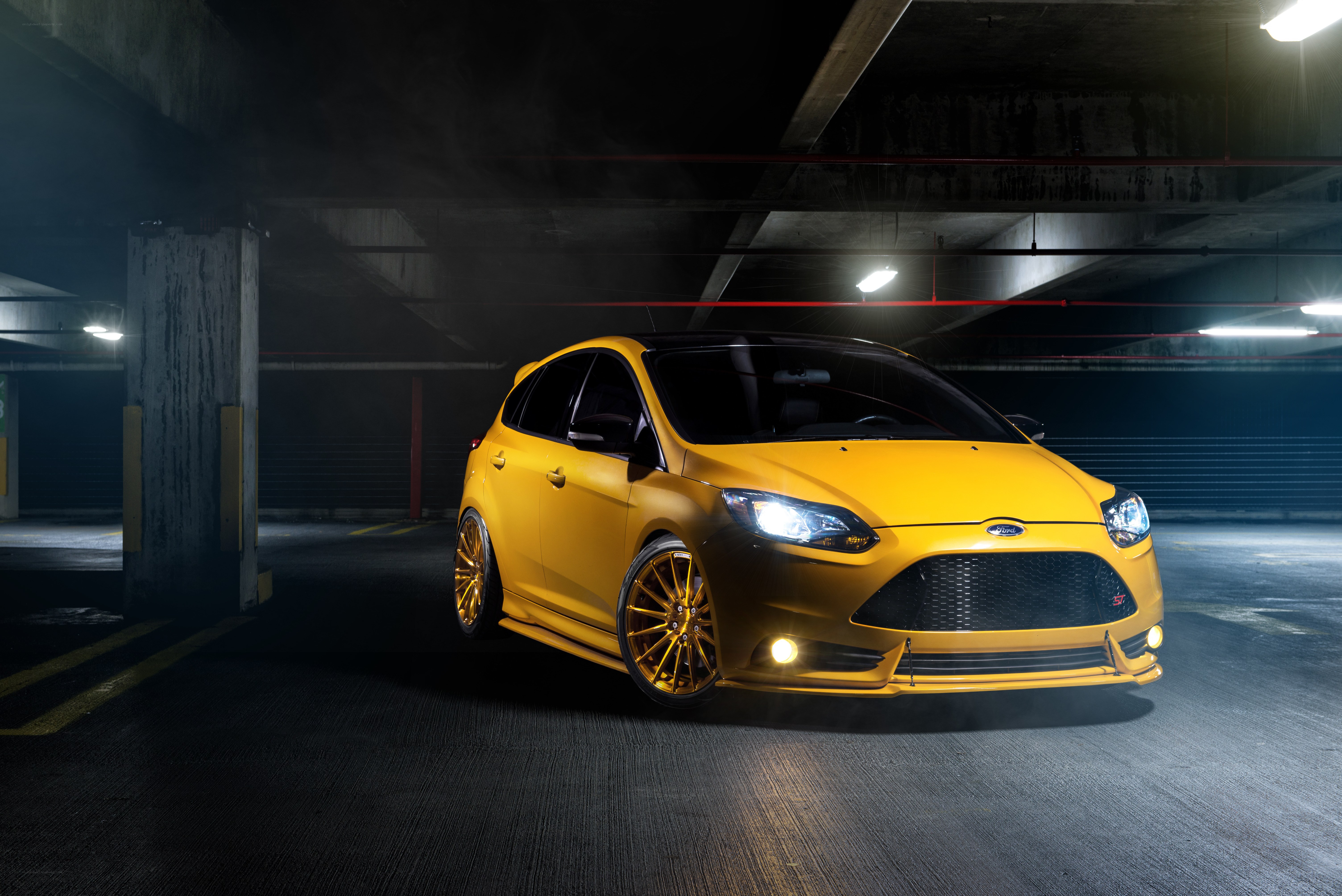 Yellow Ford Focus in parking garage