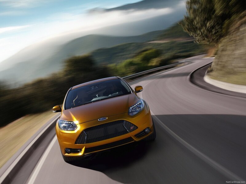 yellow ford focus st on winding road