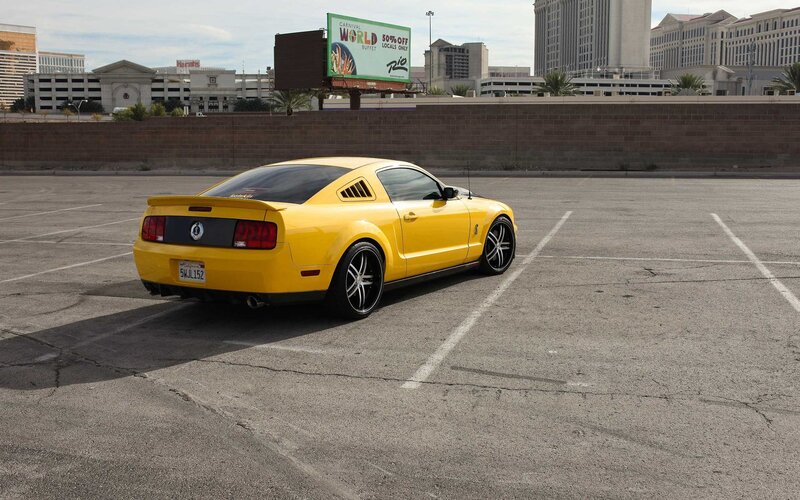 Yellow Ford Mustang in parking lot