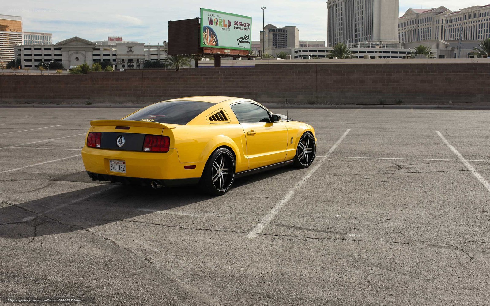 Yellow Ford Mustang in parking lot