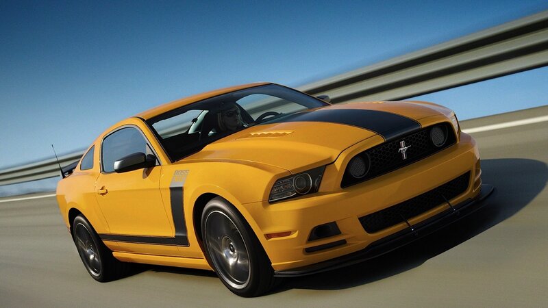 Yellow Ford Mustang on highway