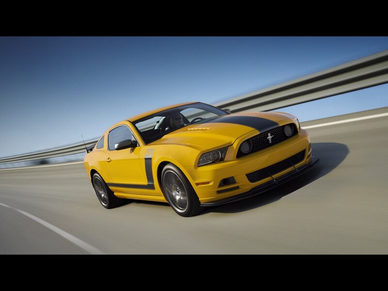 Yellow Ford Mustang on highway