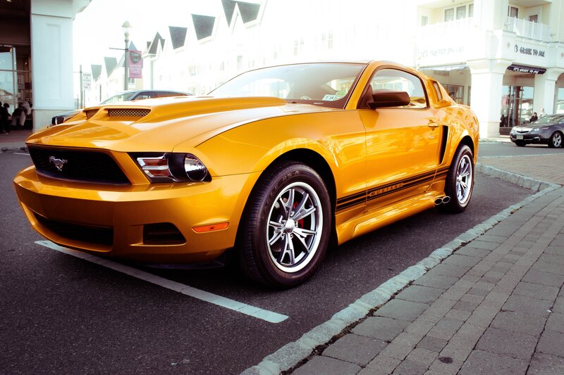 Yellow Ford Mustang parked on street