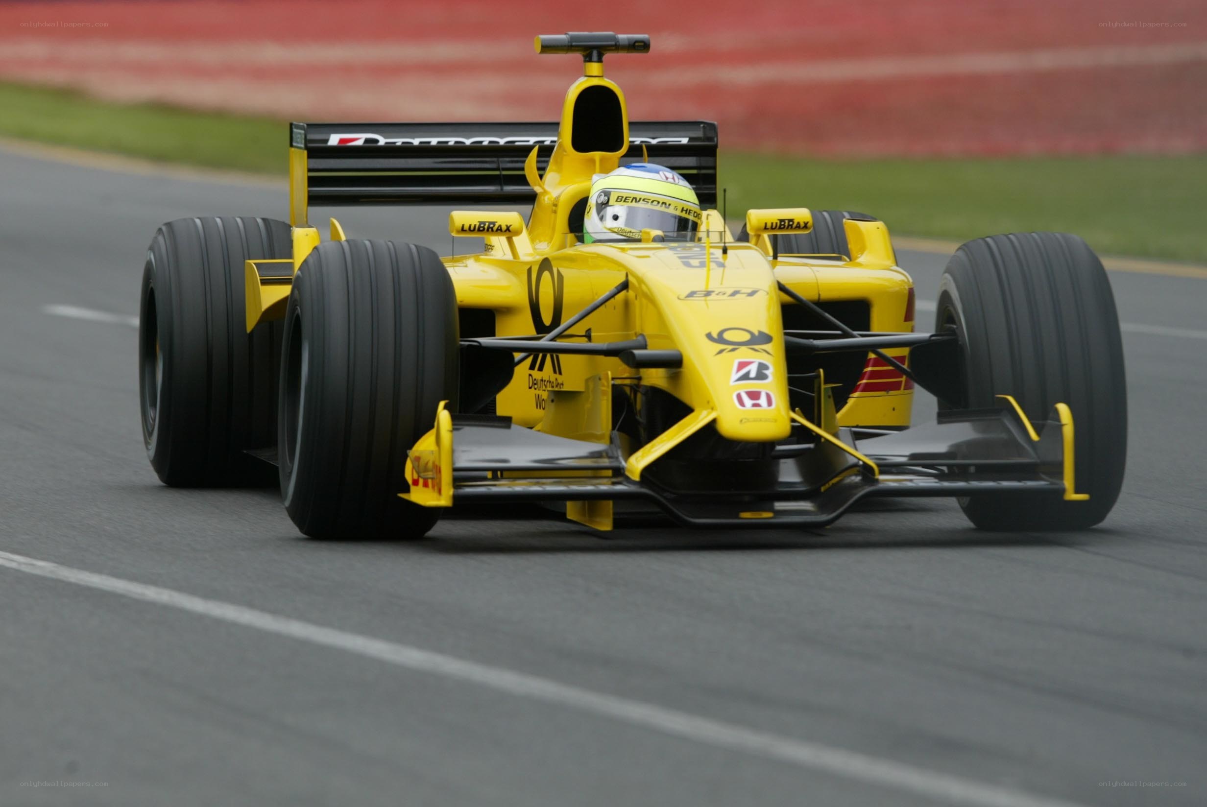 yellow formula one car on track