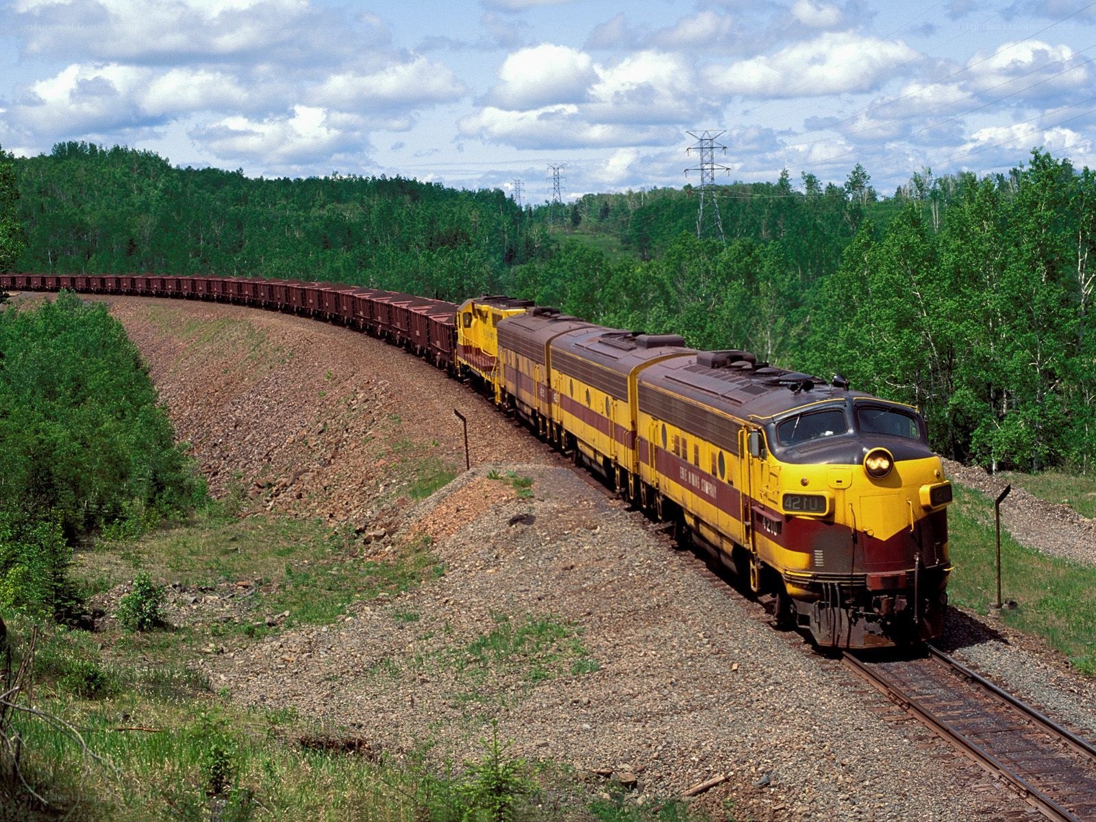 Yellow freight train on curved track