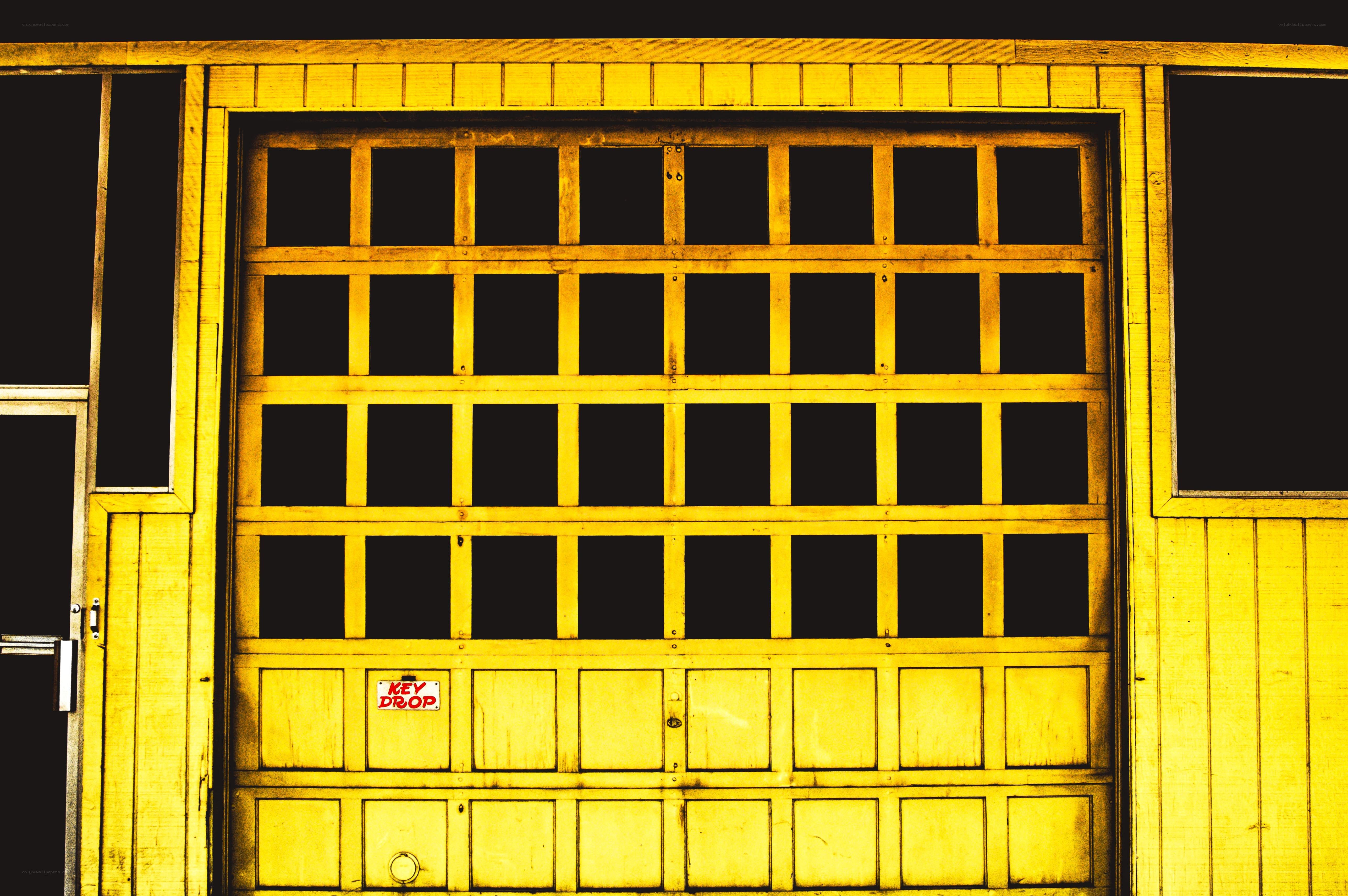 yellow garage door with key drop sign