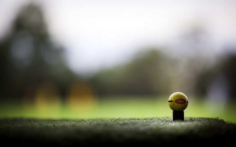 Yellow Golf Ball on Tee — Green