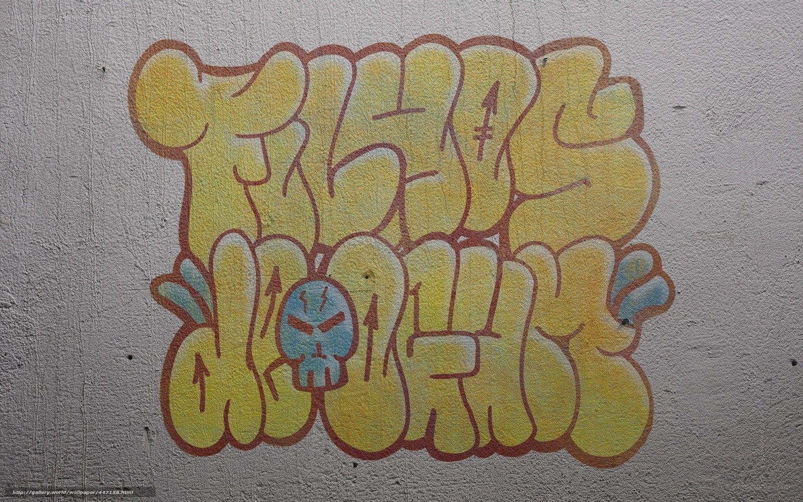 yellow graffiti on concrete wall