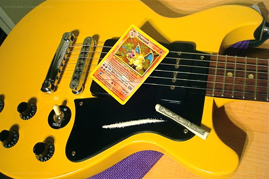 Yellow guitar with Charizard card
