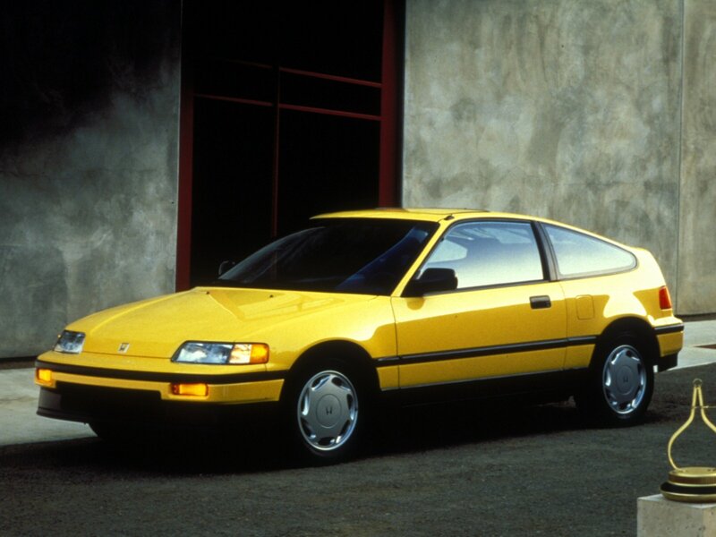 Yellow Hatchback Car — Dramatic, Photograph, Building