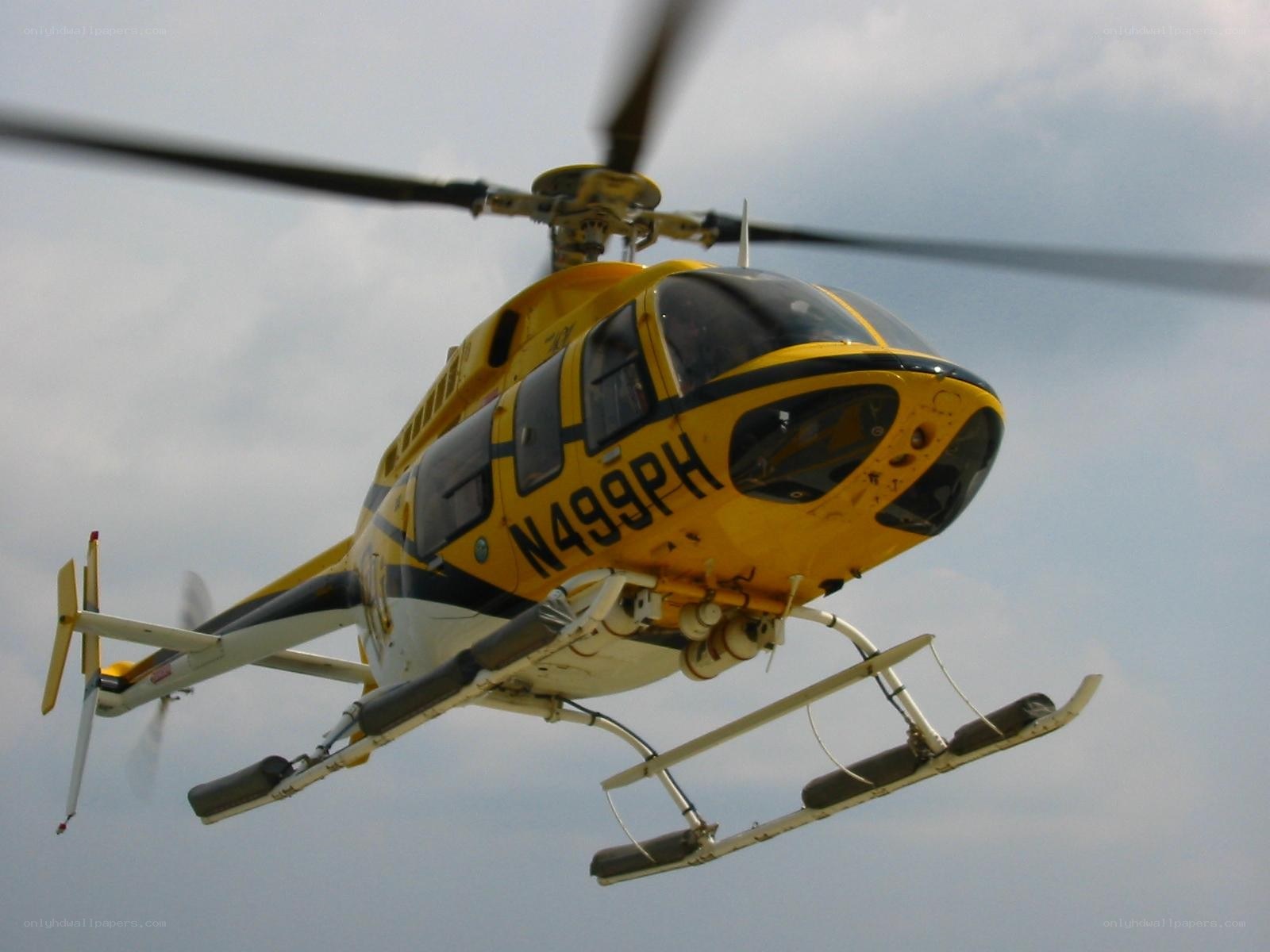 Yellow helicopter in flight