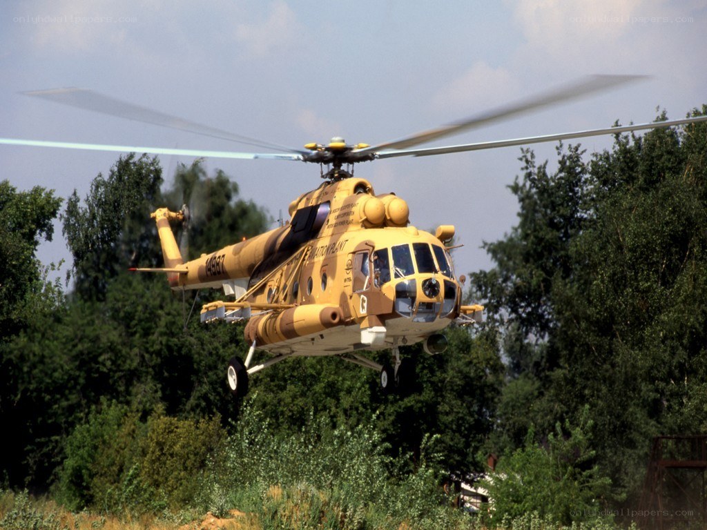 Yellow helicopter in flight
