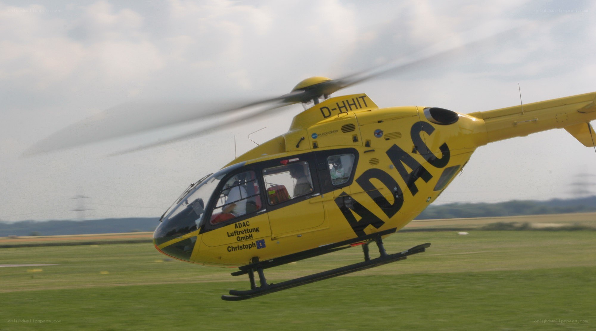 Yellow helicopter in flight