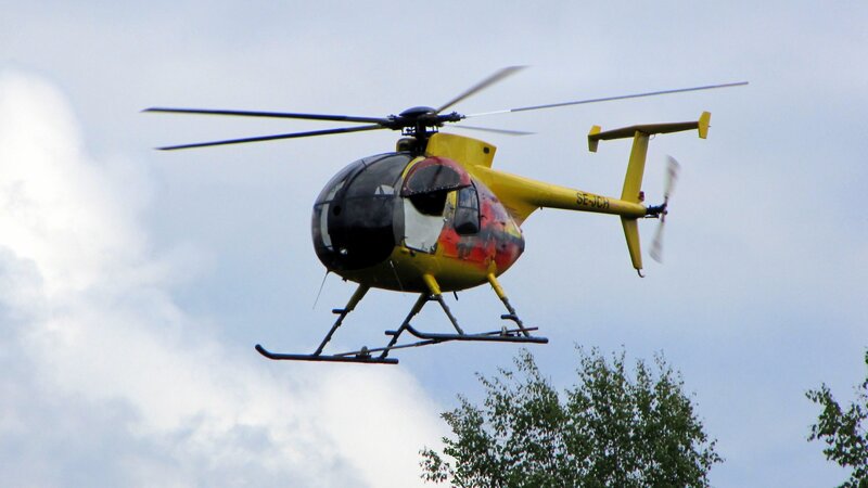 Yellow Helicopter in Flight — Overcast