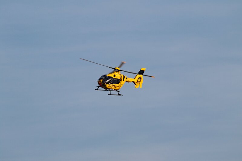 Yellow helicopter in flight