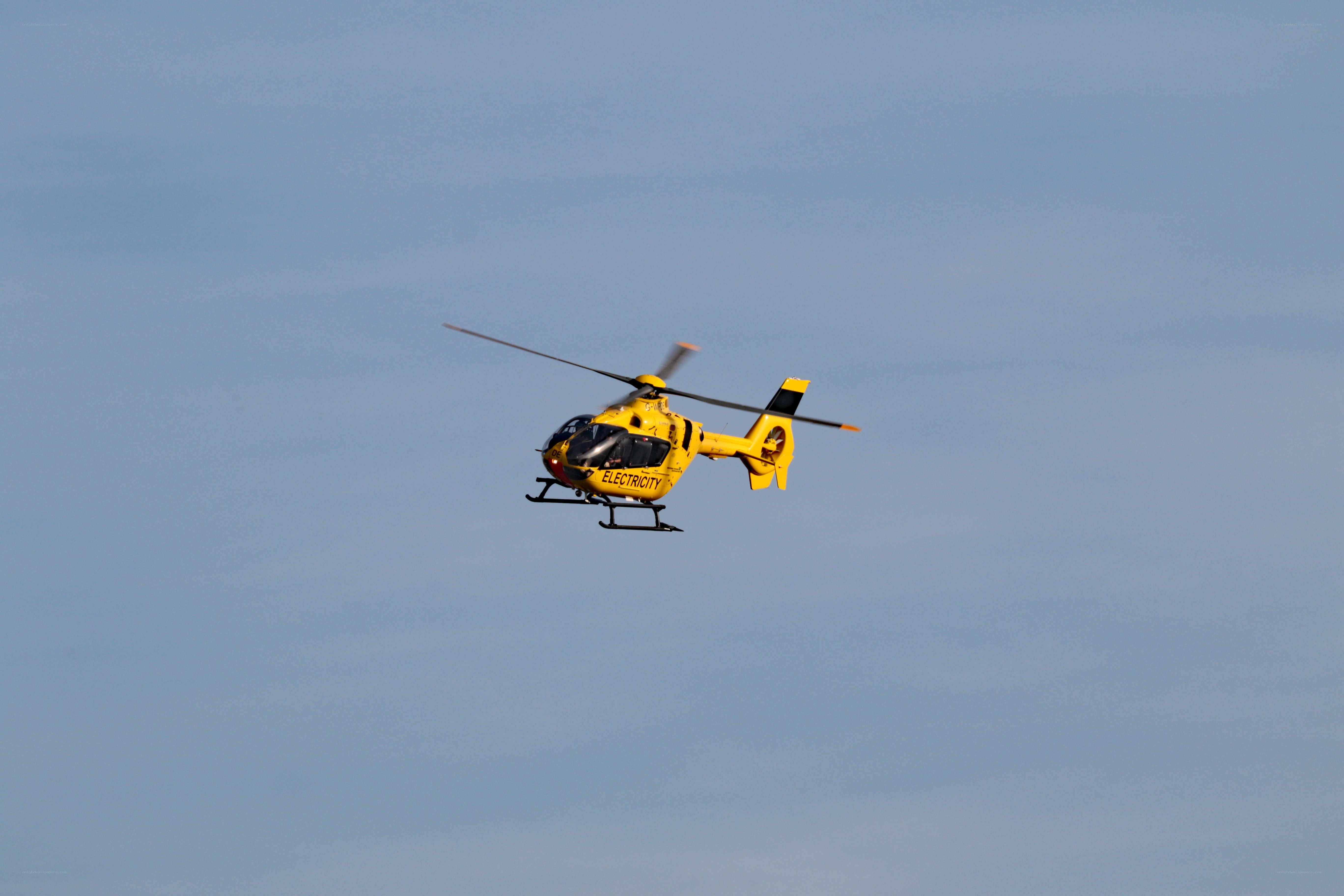 Yellow helicopter in flight