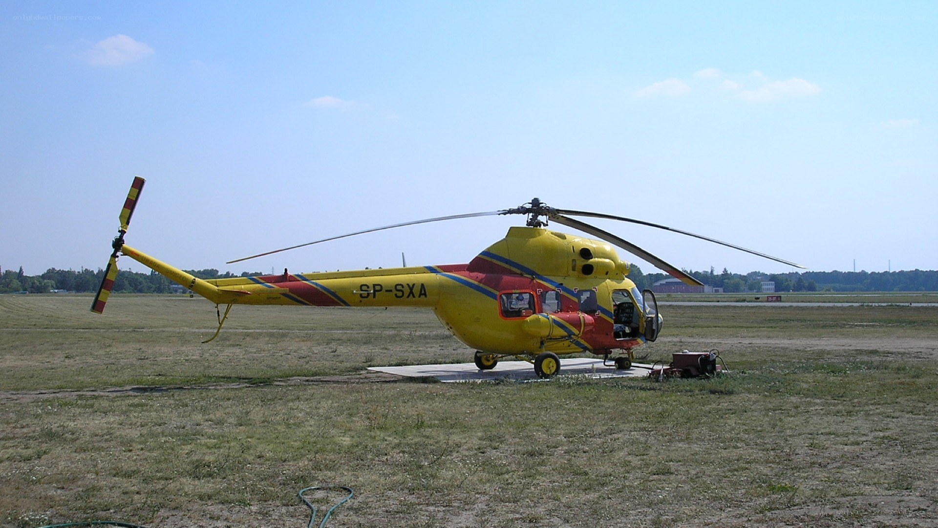 Yellow helicopter on grass field