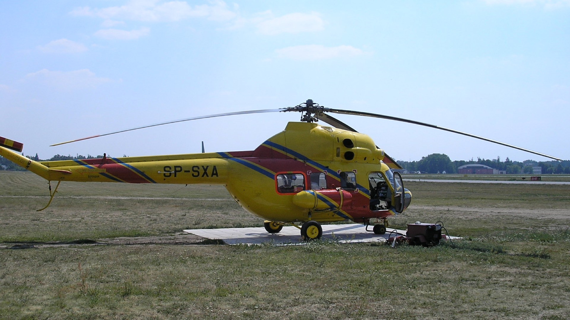 Yellow helicopter on grass field