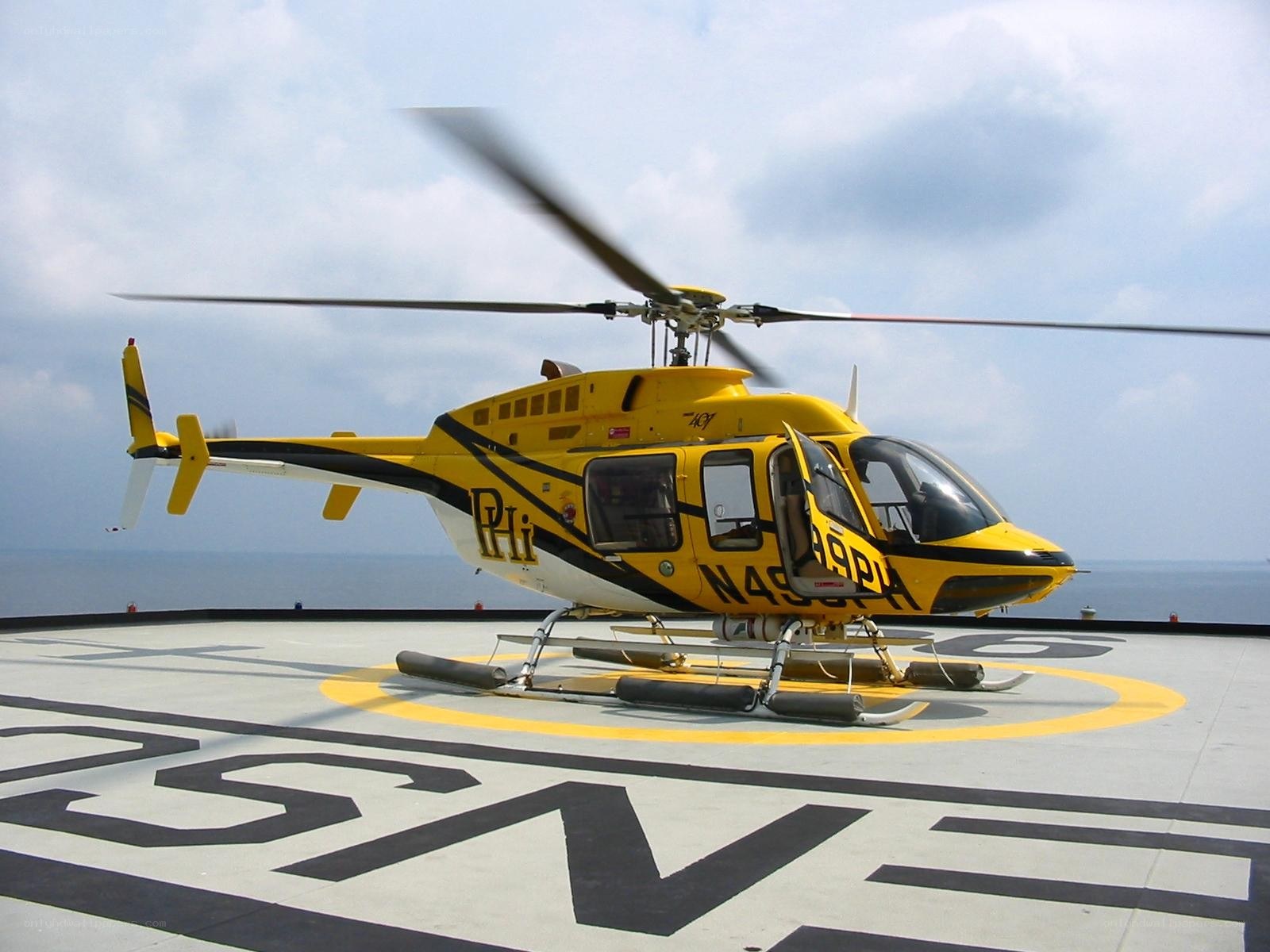 Yellow helicopter on helipad