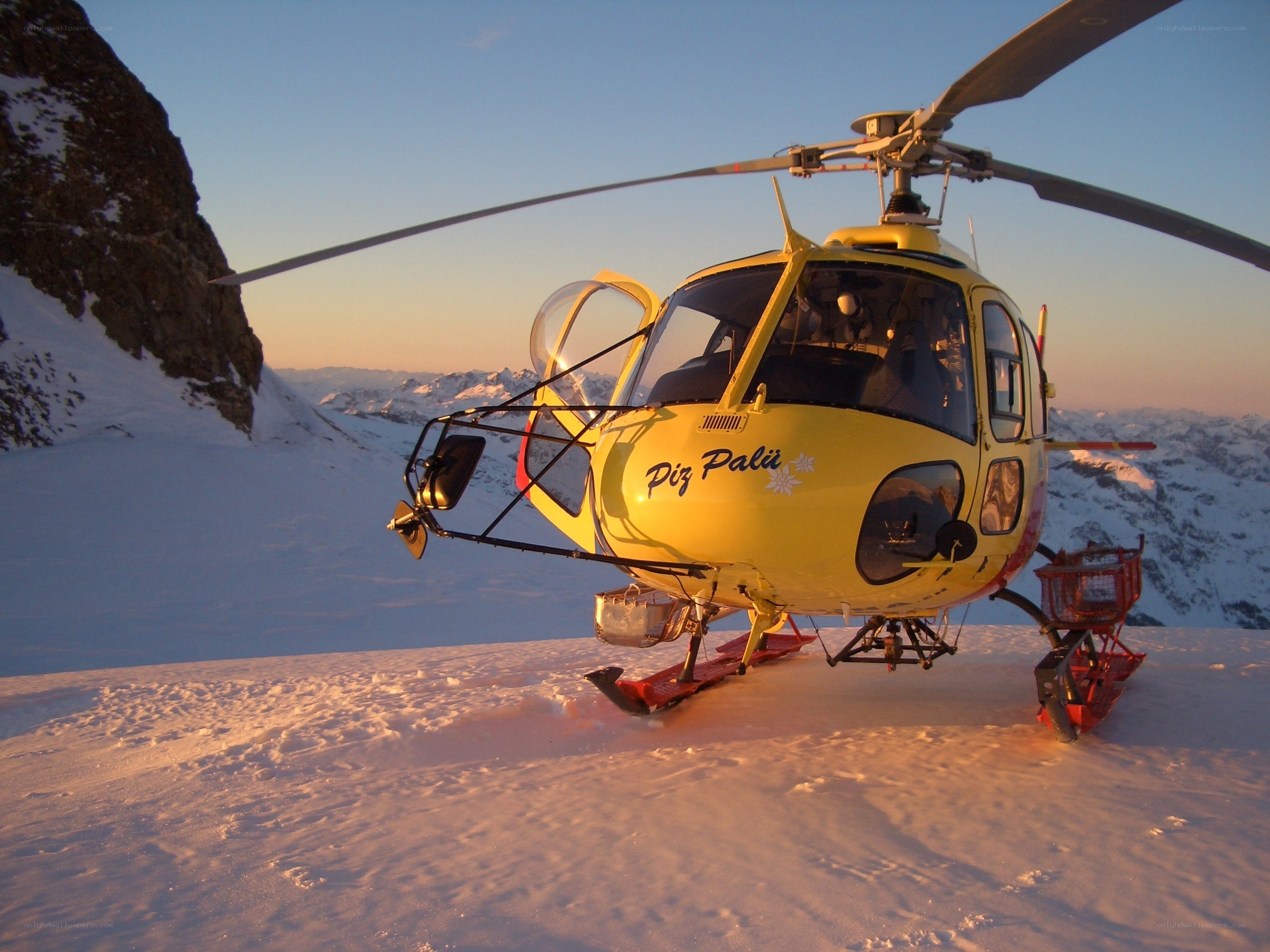 Yellow helicopter on snowy mountain