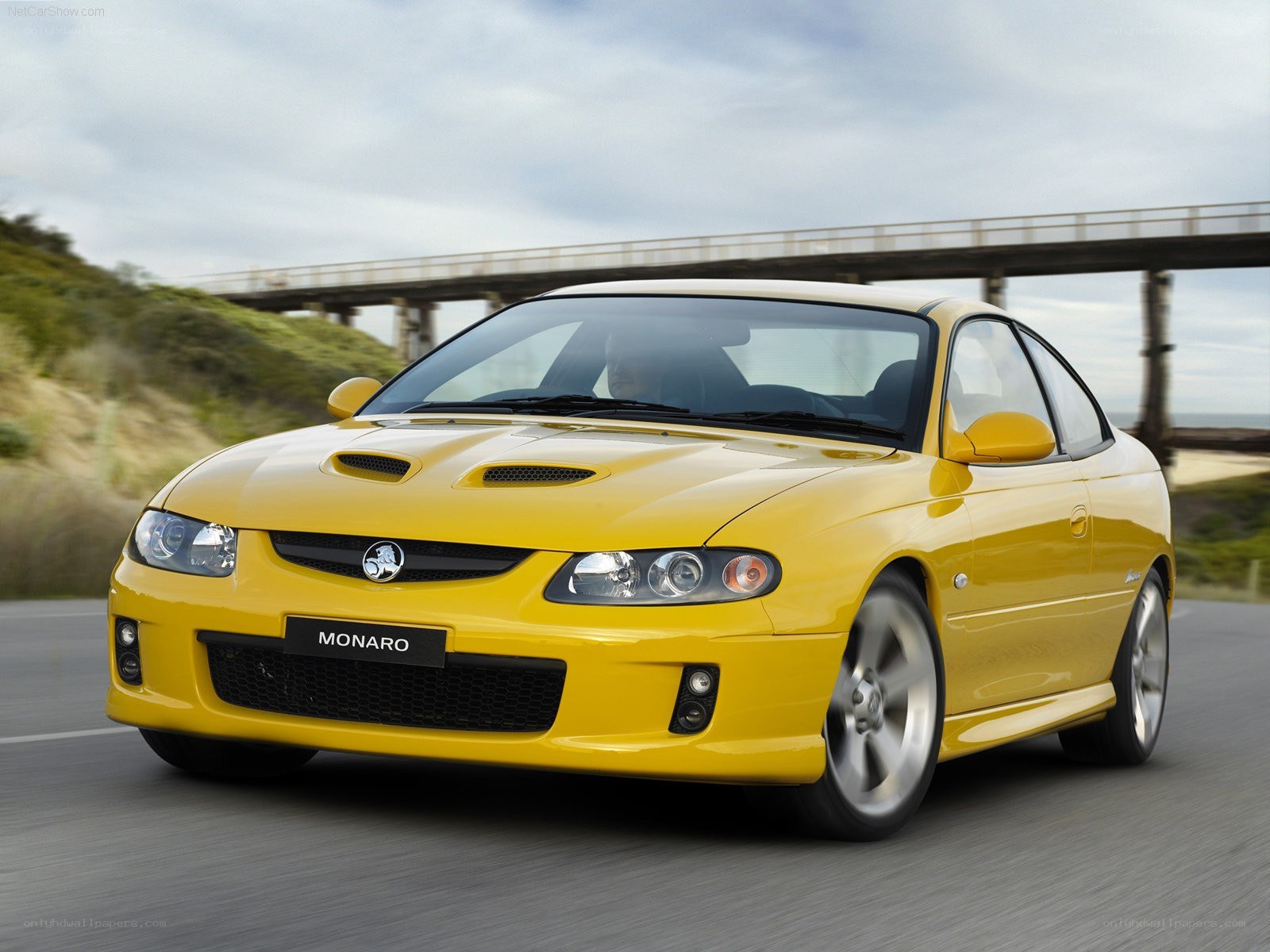 yellow Holden Monaro in motion