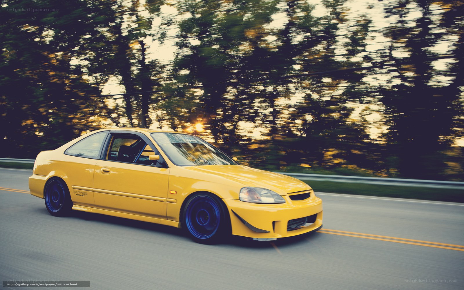 Yellow Honda Civic on a road