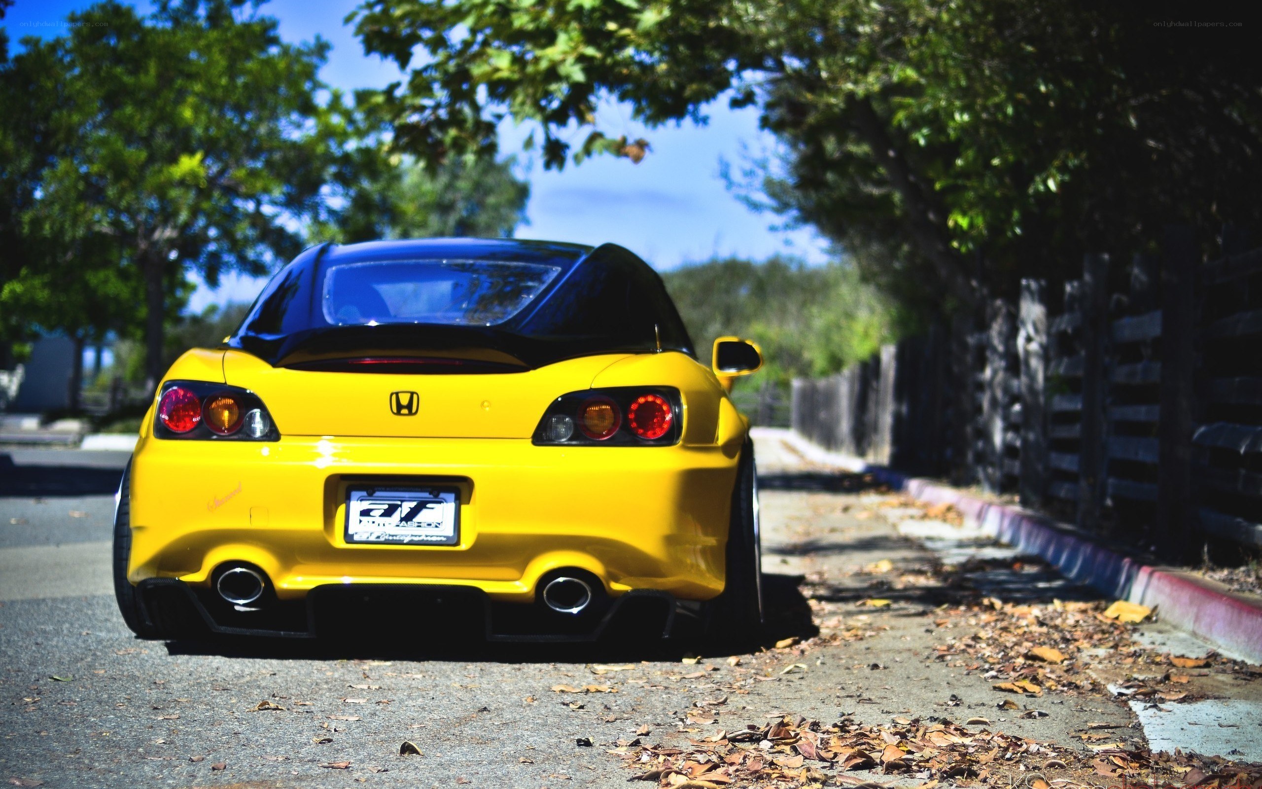yellow honda s2000 parked