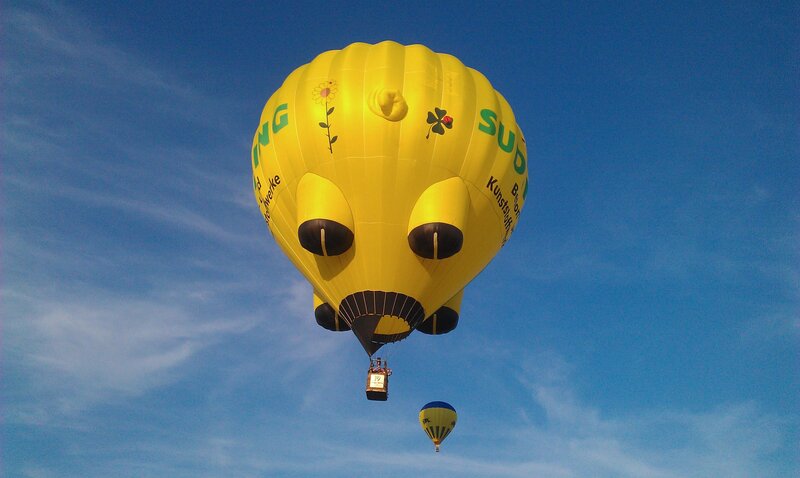 Yellow hot air balloon in sky