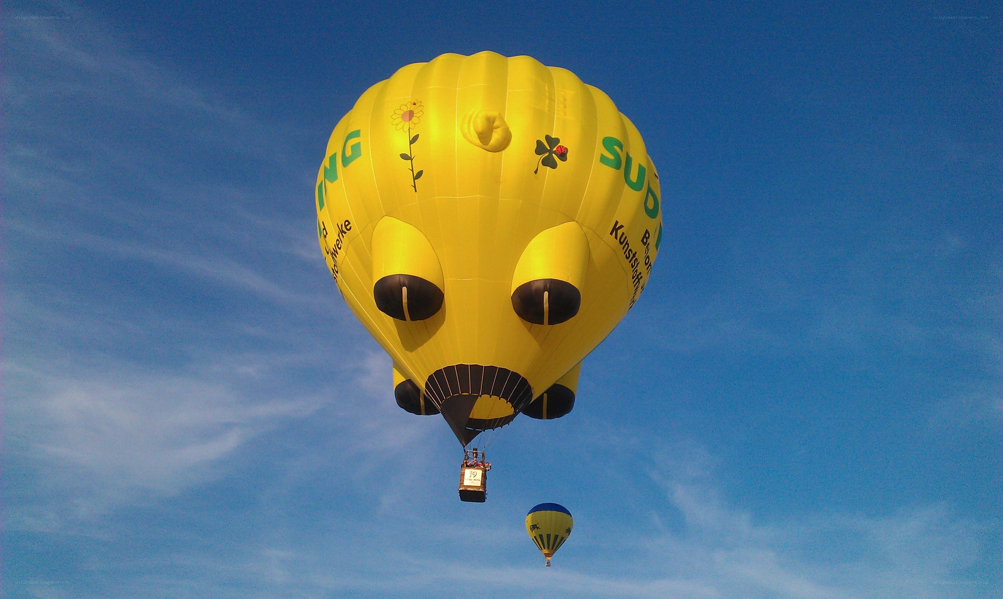 Yellow hot air balloon in sky