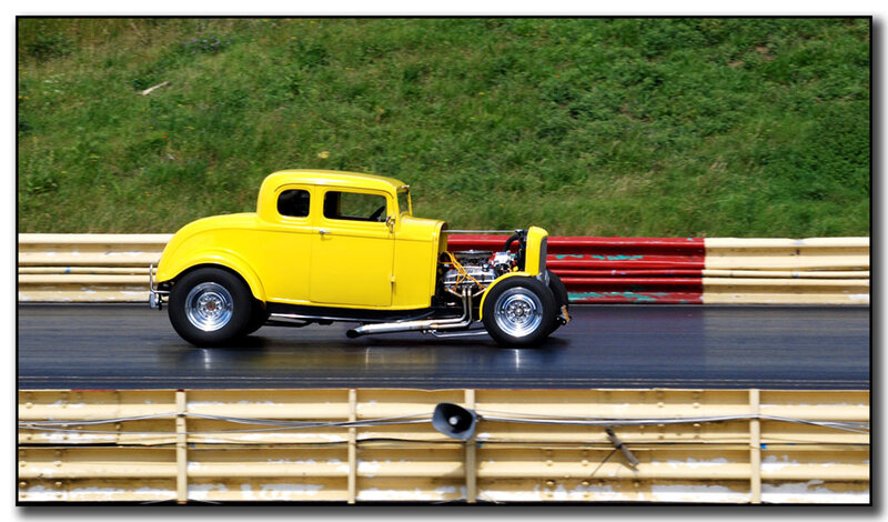 yellow hot rod on drag strip