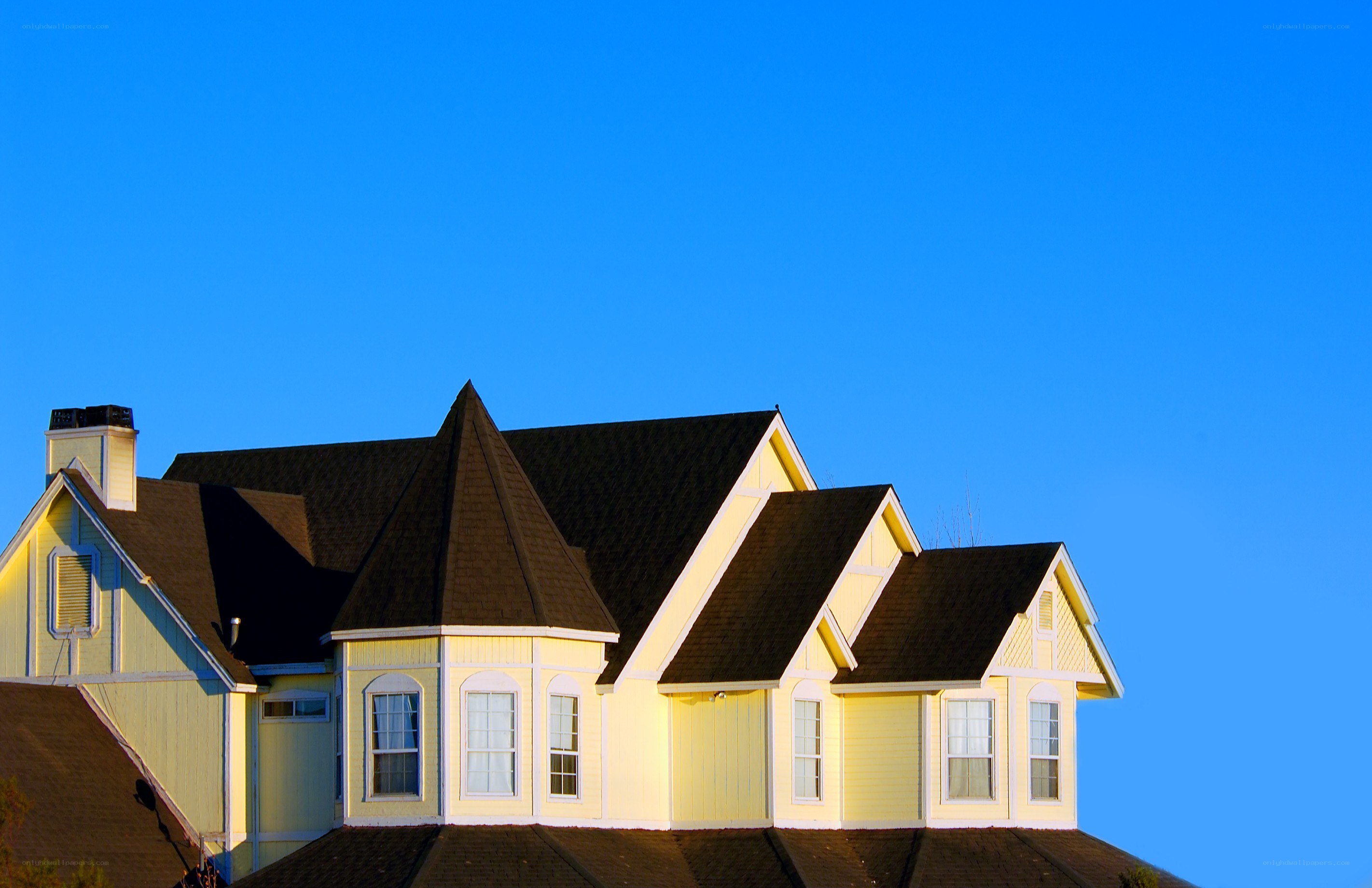 yellow house with blue sky