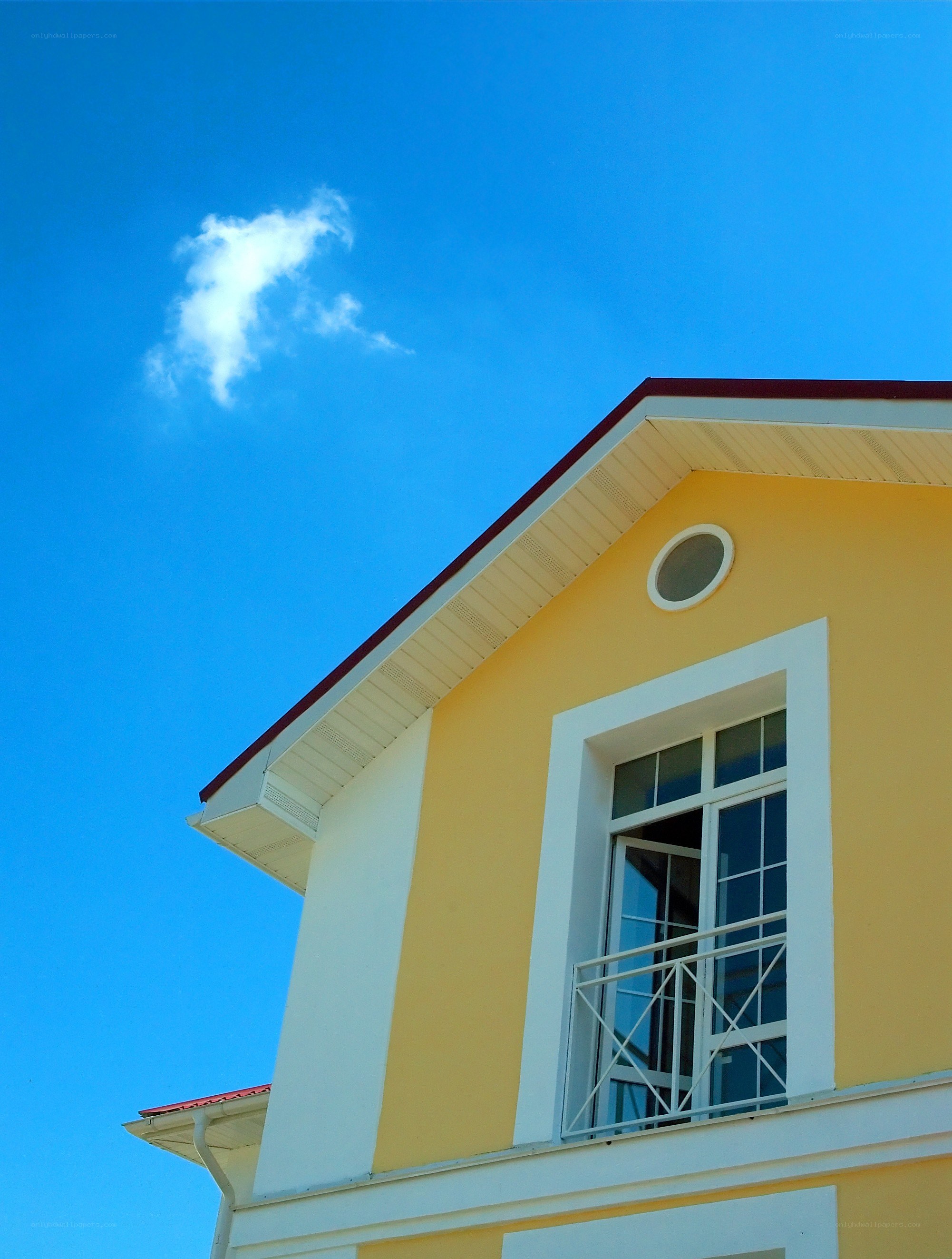 yellow house with blue sky
