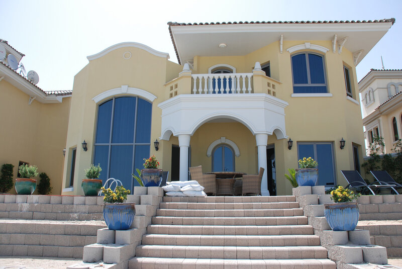 yellow house with blue windows