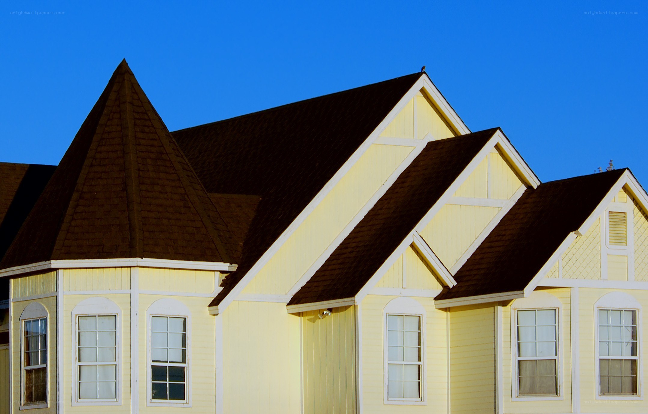 yellow house with brown roof