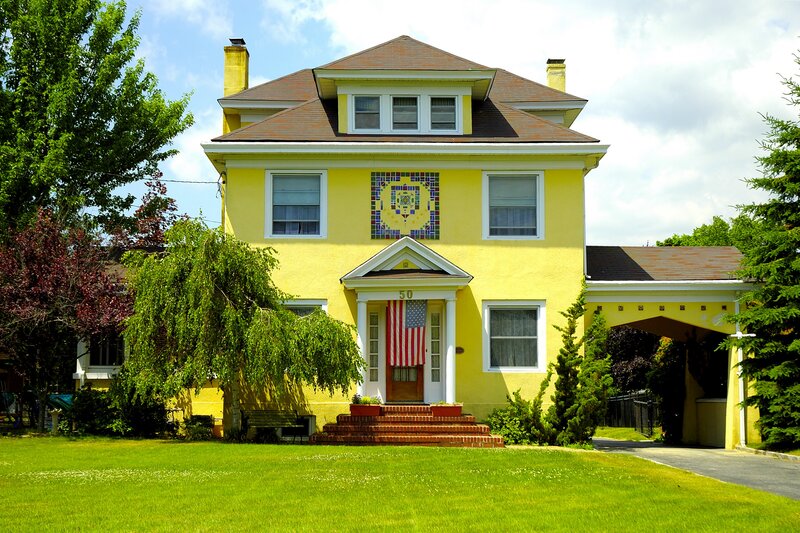 yellow house with mosaic art