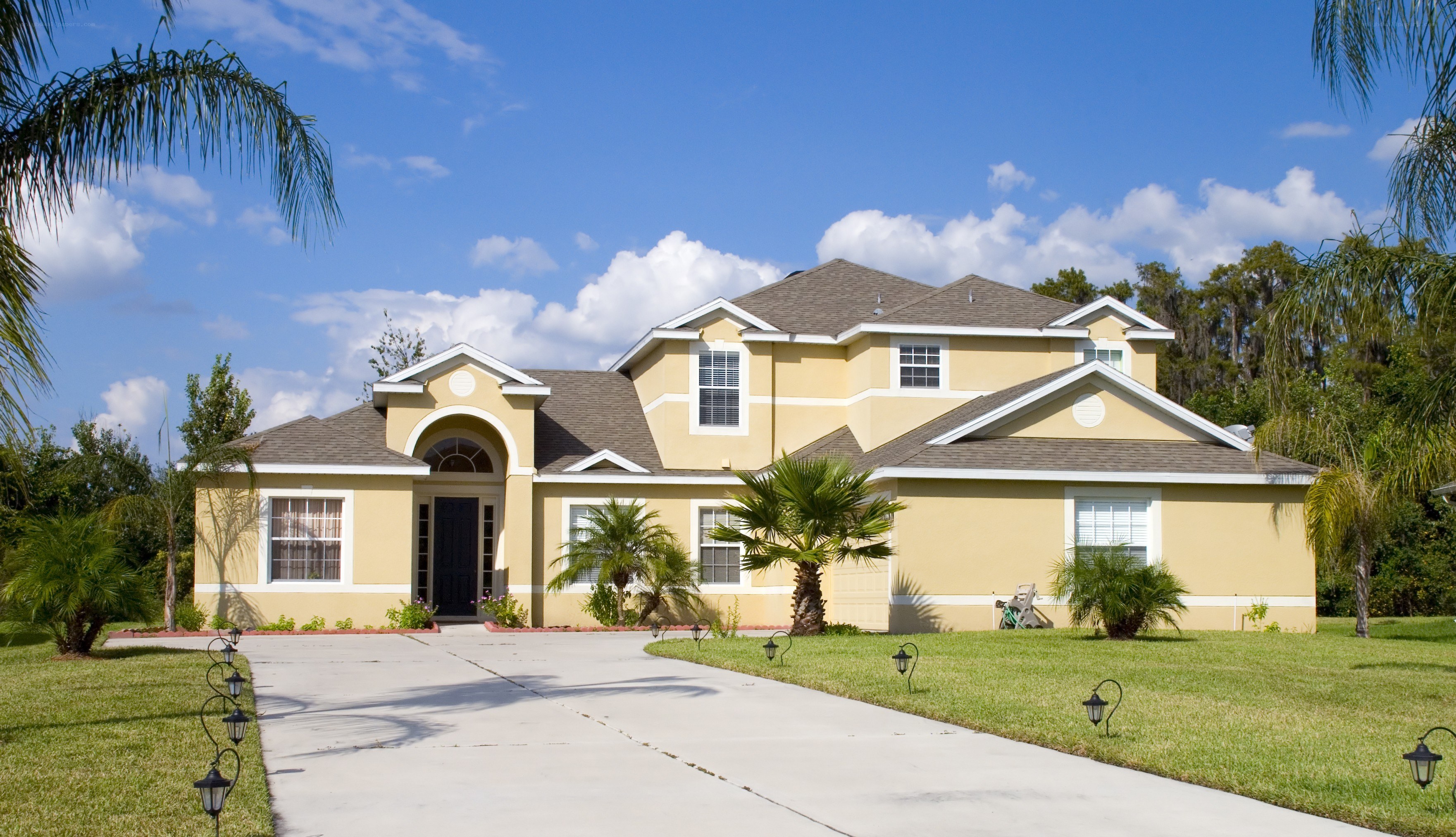 yellow house with palm trees