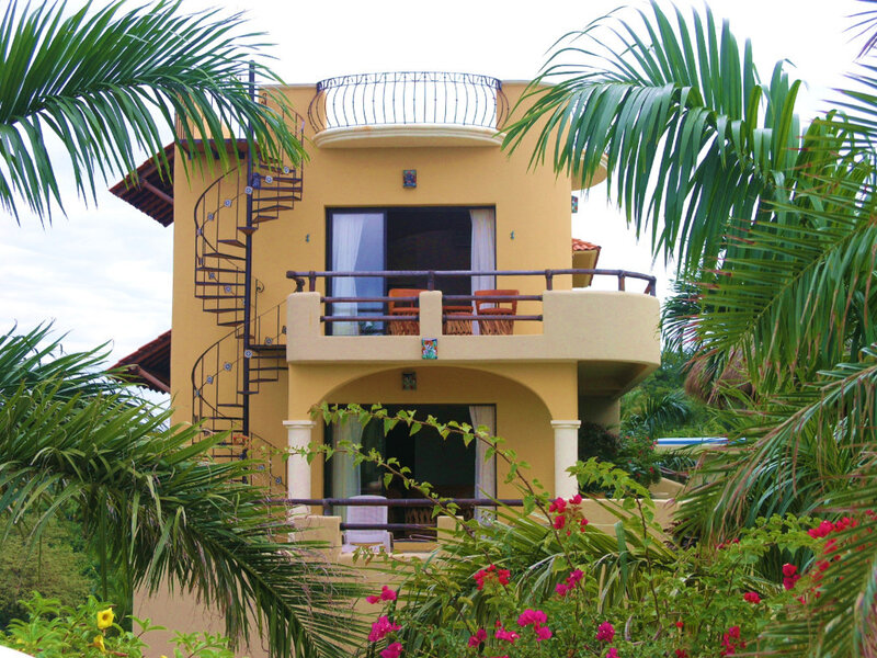 yellow house with spiral staircase