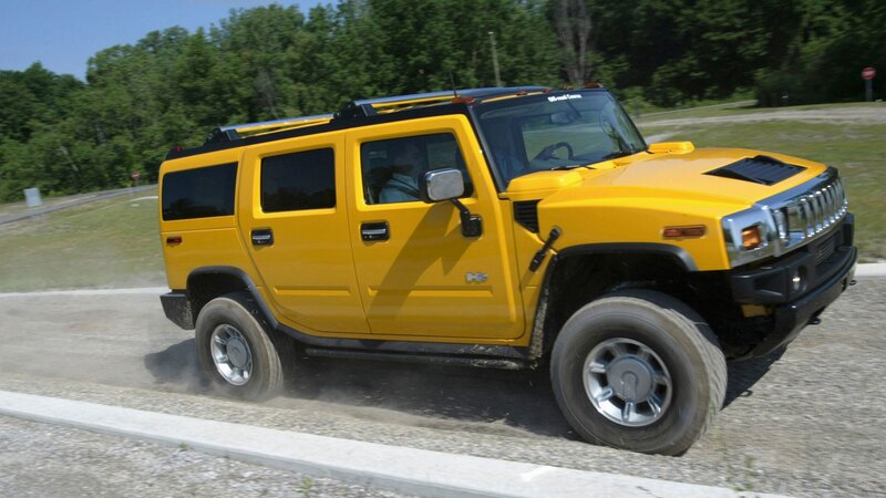 yellow hummer driving on road